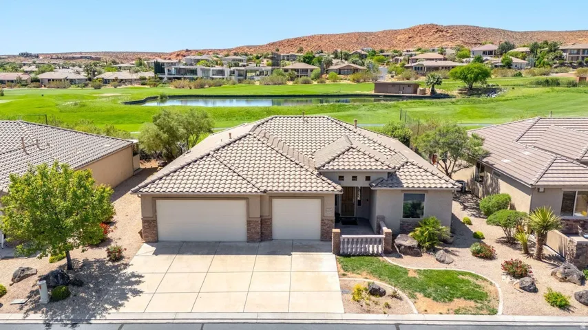 Aerial view of residential area with a water and mountain view and a local golf course