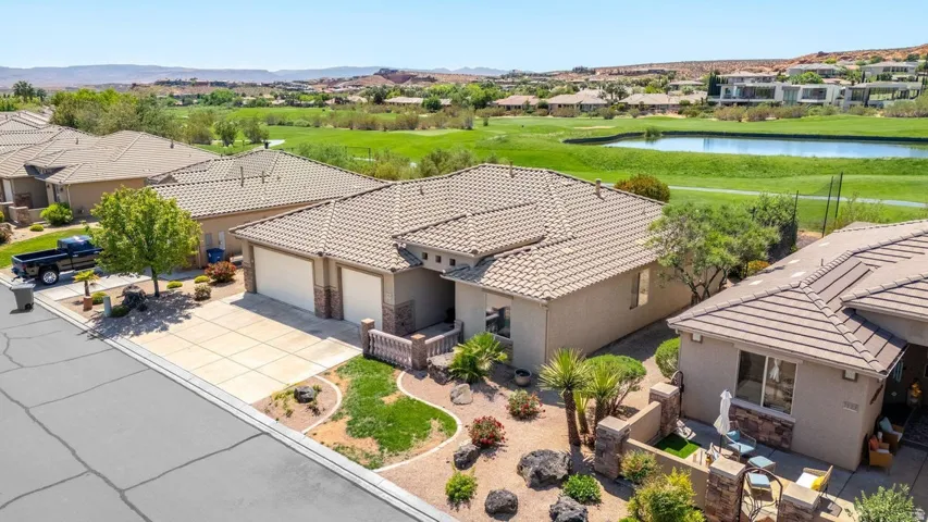 Aerial view of residential area featuring a water and mountain view and a local golf course