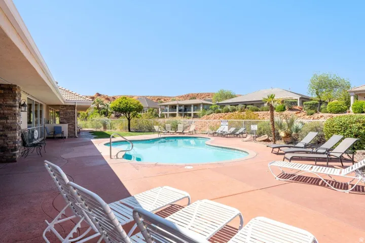 Community pool featuring a patio area and a residential view