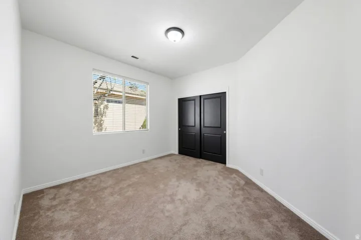 Unfurnished bedroom featuring carpet floors and a closet