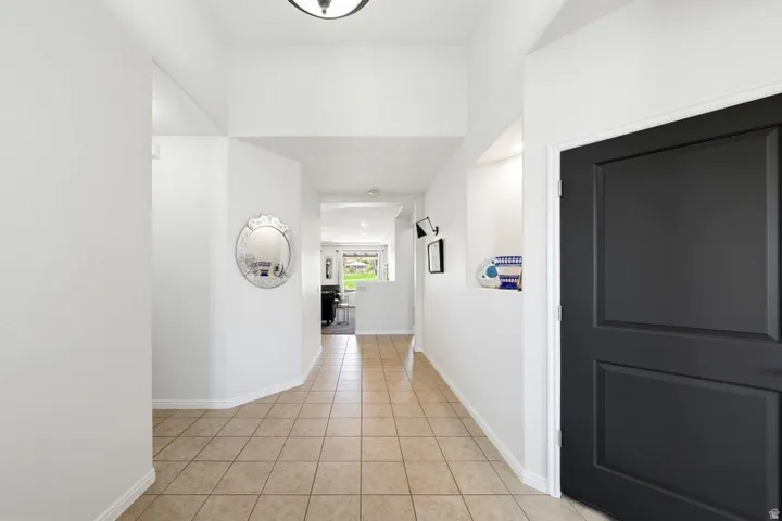 Hall featuring light tile patterned flooring and recessed lighting