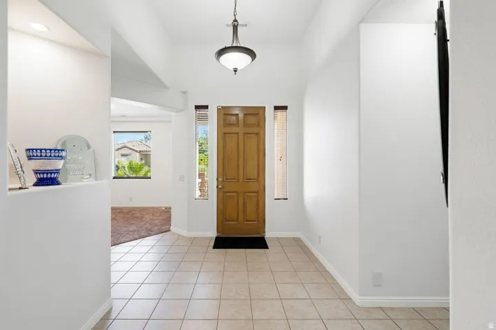 Entryway featuring baseboards and light tile patterned floors