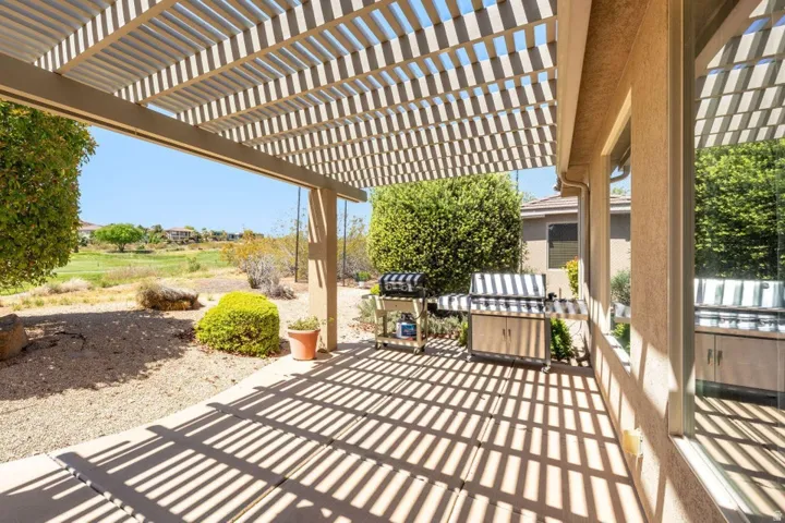 View of patio with a pergola and a grill