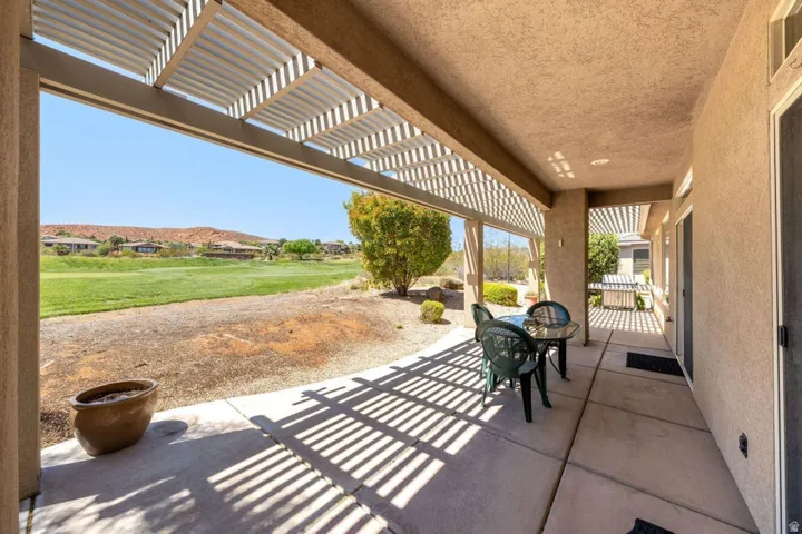 View of patio with a pergola, outdoor dining space, and a residential view