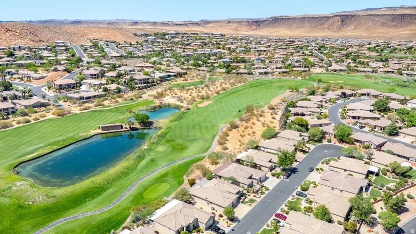 Aerial view of residential area with a water and mountain view and a golf club