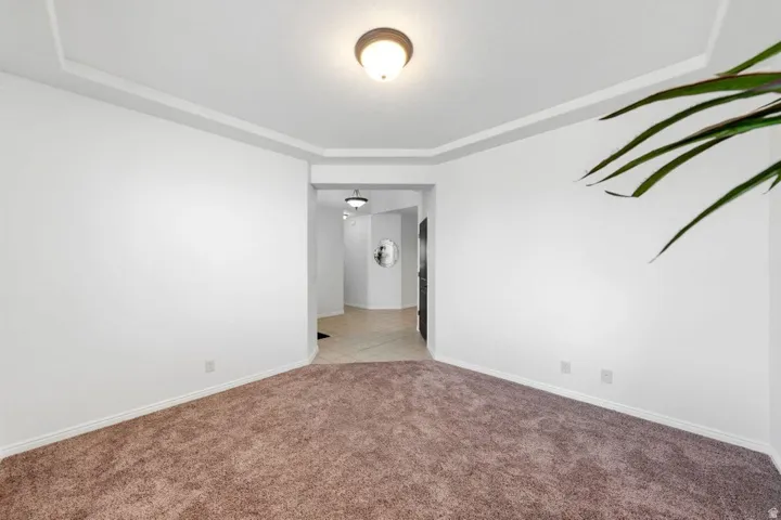 Unfurnished room with light carpet and baseboards