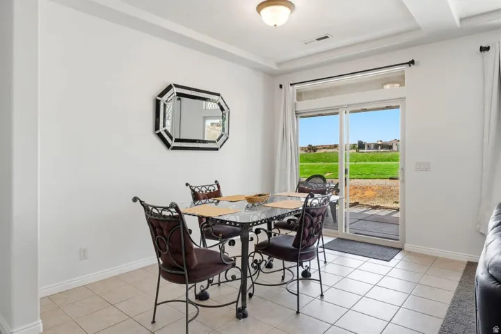 Dining space featuring light tile patterned floors