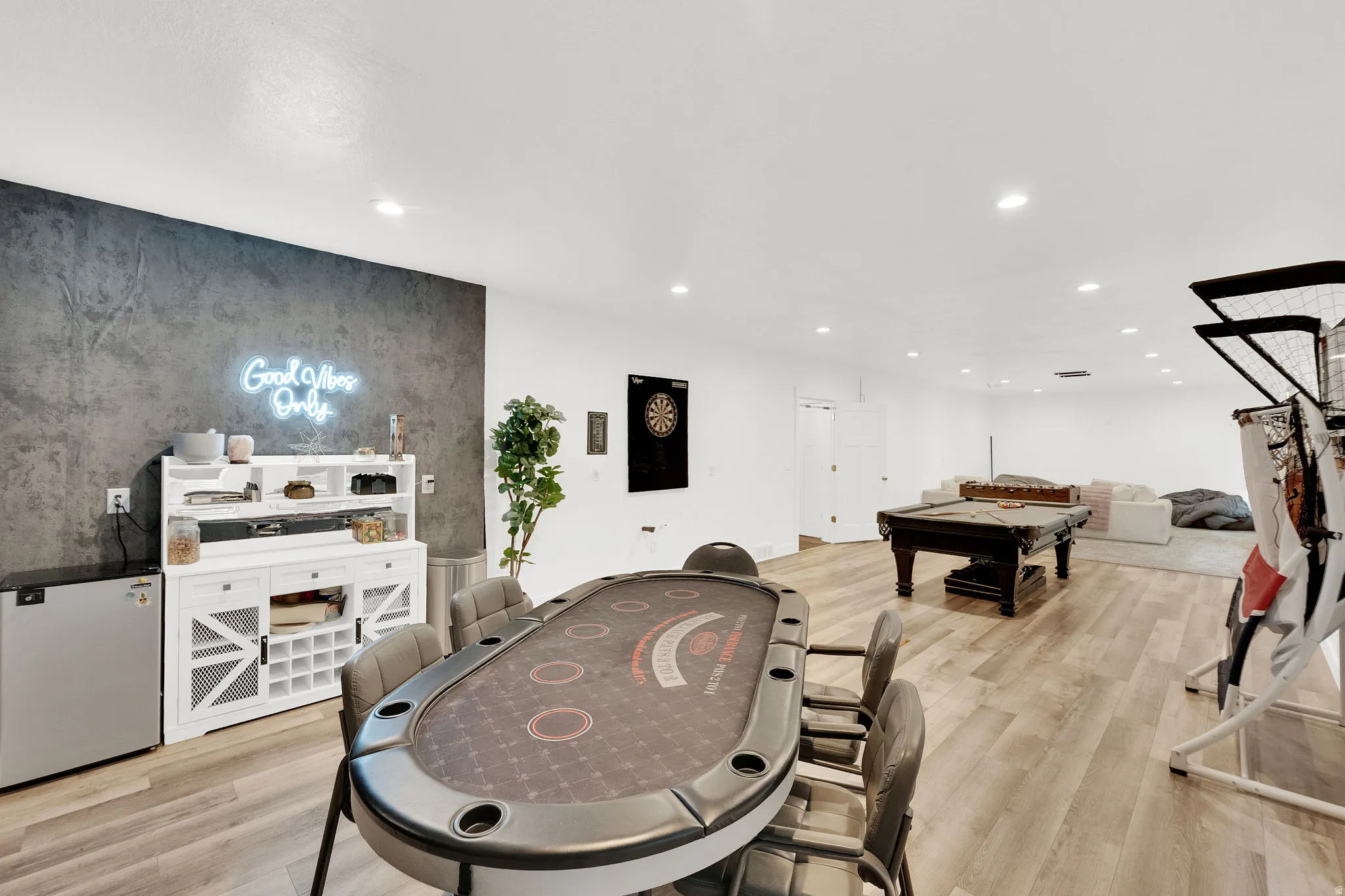 Playroom featuring light wood-style flooring, billiards, an accent wall, and recessed lighting