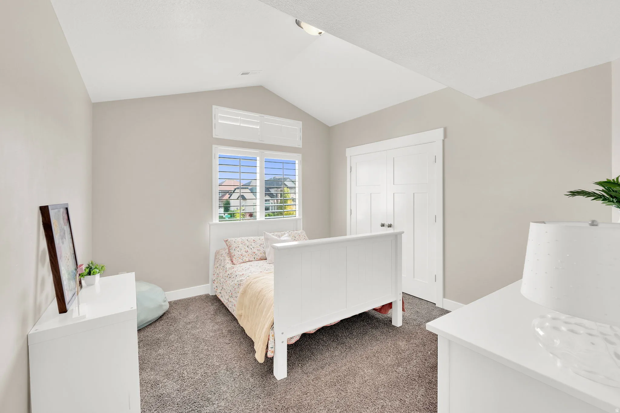 Bedroom with dark carpet and baseboards