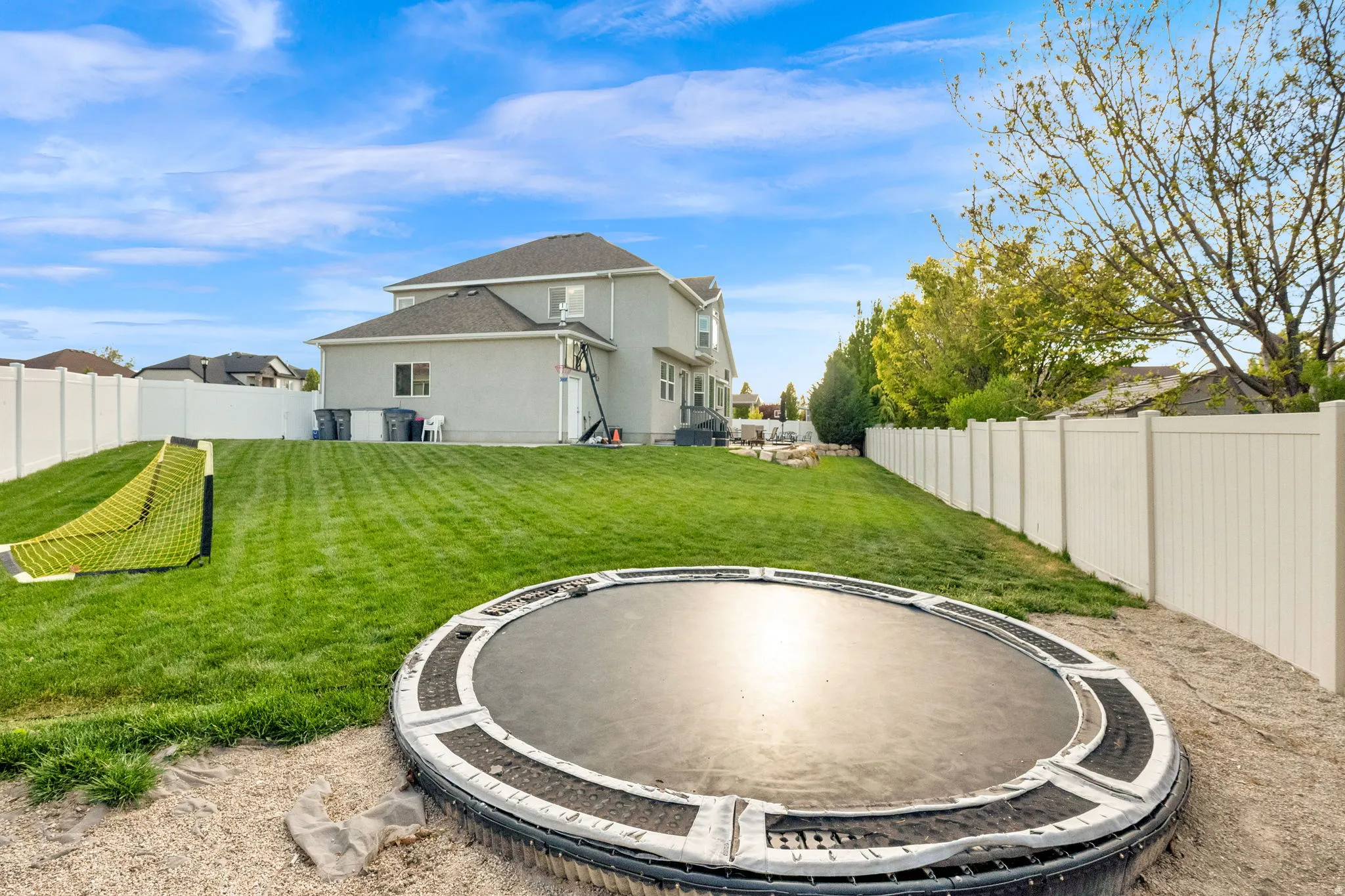 Rear view of property with a fenced backyard and stucco siding