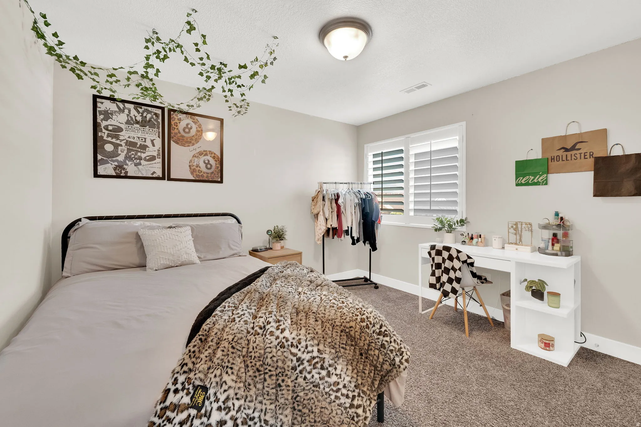 Bedroom featuring baseboards and dark carpet