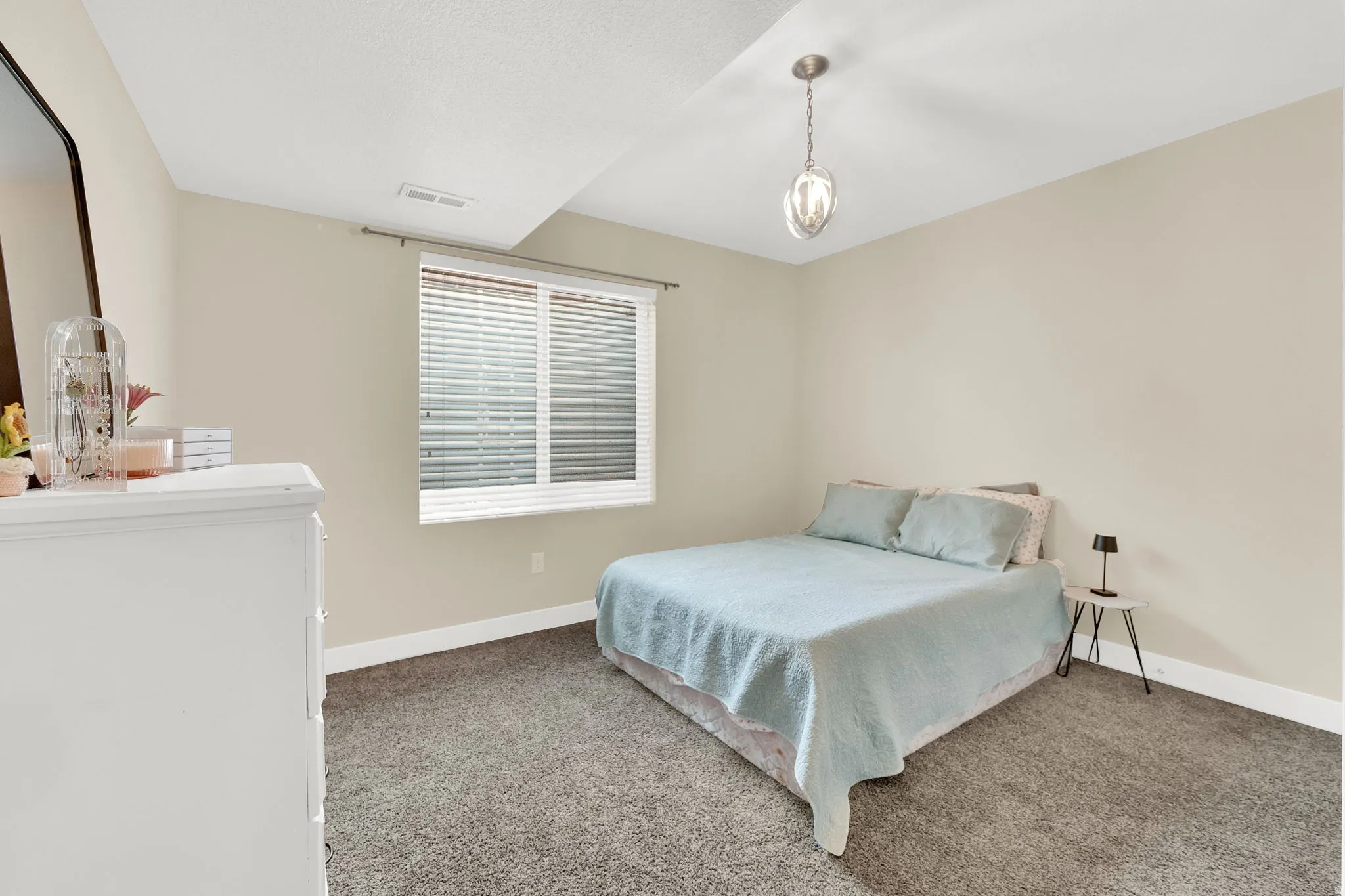 Bedroom with dark carpet and baseboards