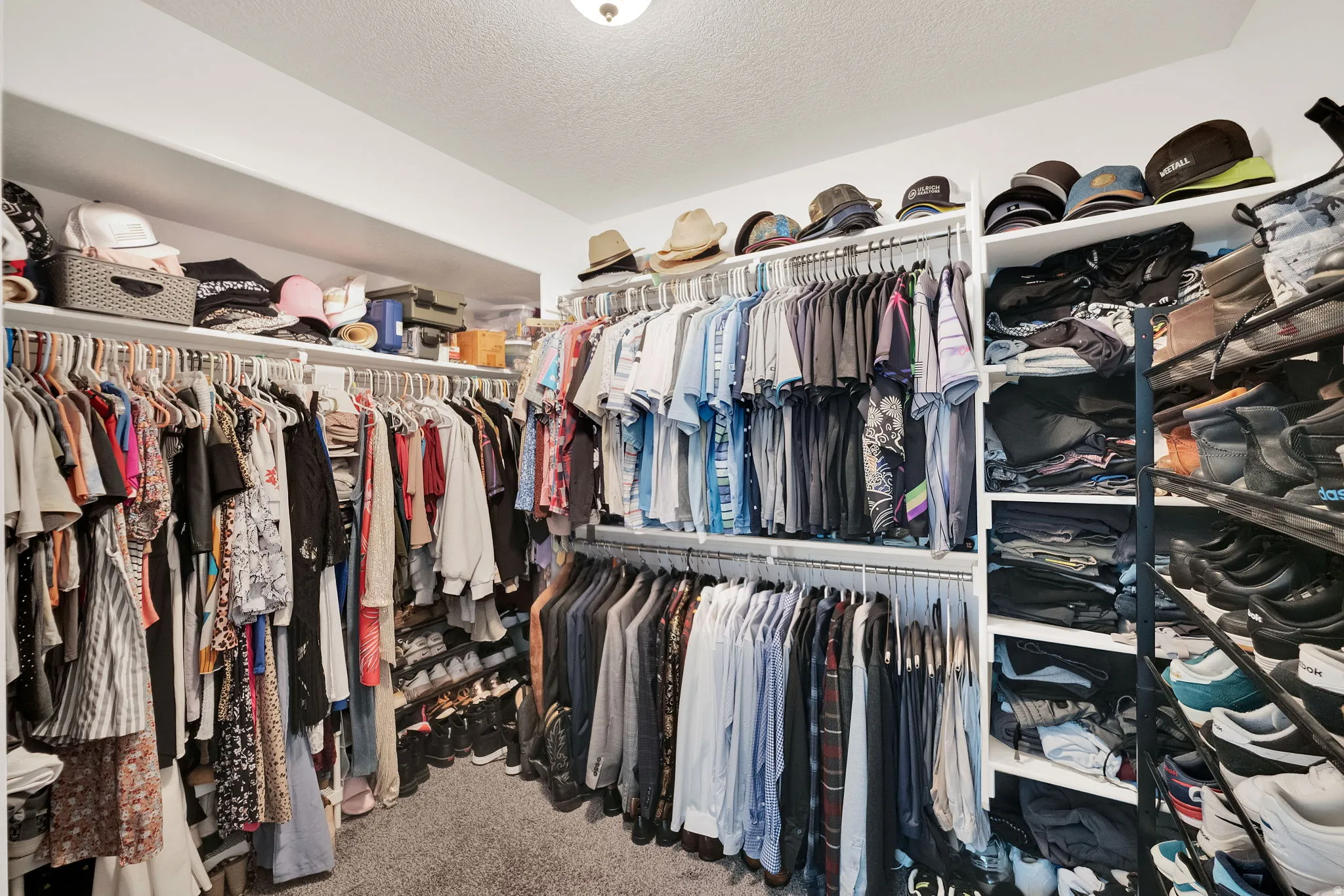 Walk in closet featuring light carpet