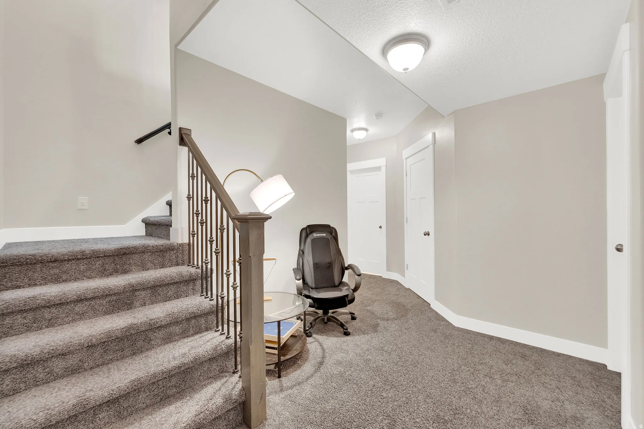 Unfurnished office featuring carpet floors and a textured ceiling