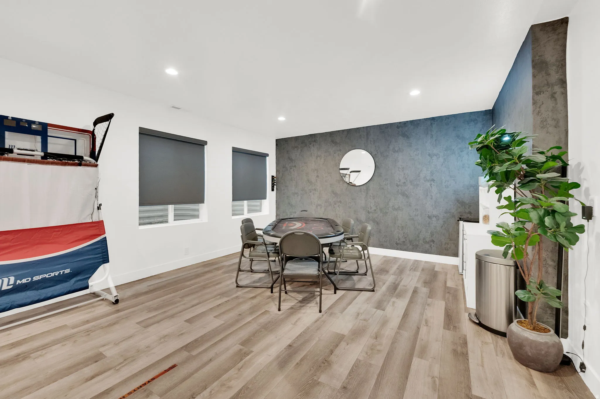 Dining area featuring an accent wall, recessed lighting, light wood-style flooring, and wallpapered walls