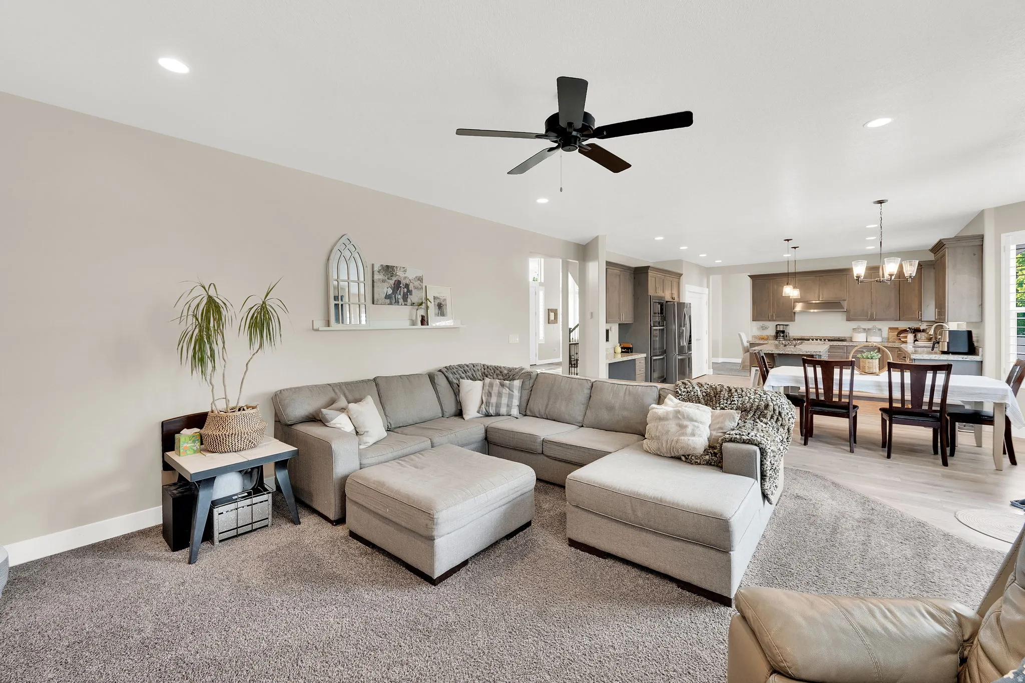 Living room featuring a chandelier and a ceiling fan