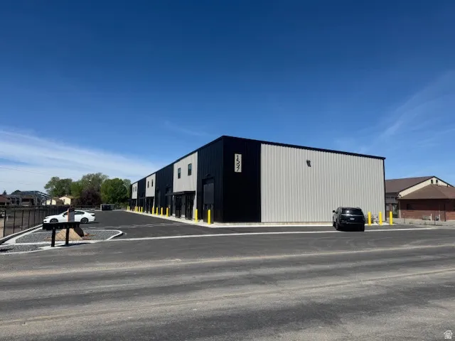 View of building exterior with uncovered parking