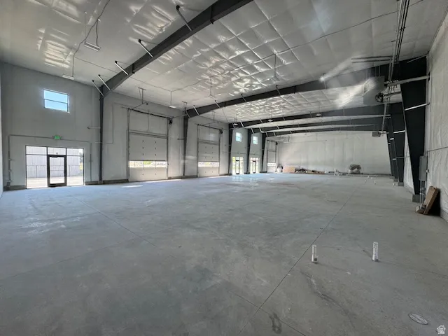 Misc room featuring a high ceiling and a garage
