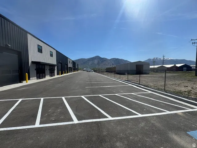 Surrounding community with a mountain view and uncovered parking