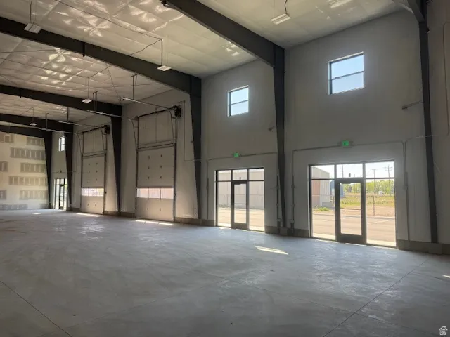 Miscellaneous room with a high ceiling and a garage