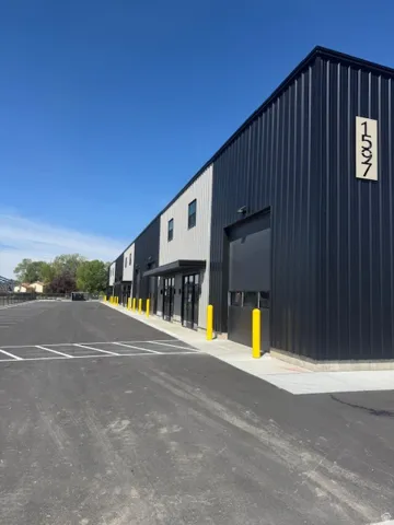 View of building exterior with uncovered parking