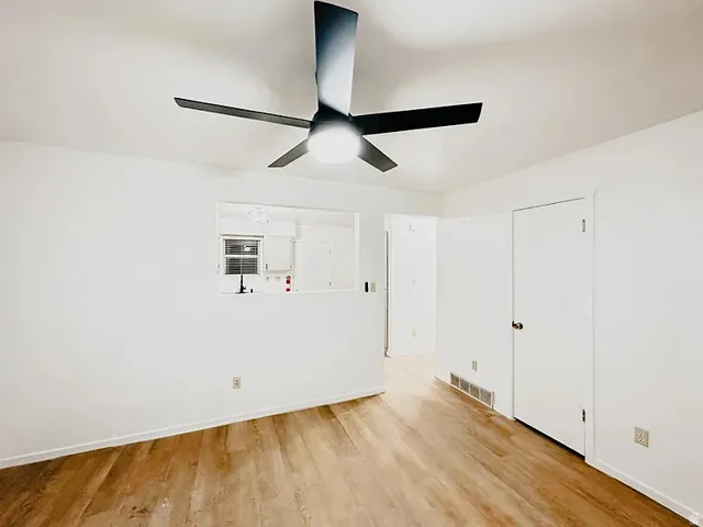 Spare room with light wood-style floors and a ceiling fan