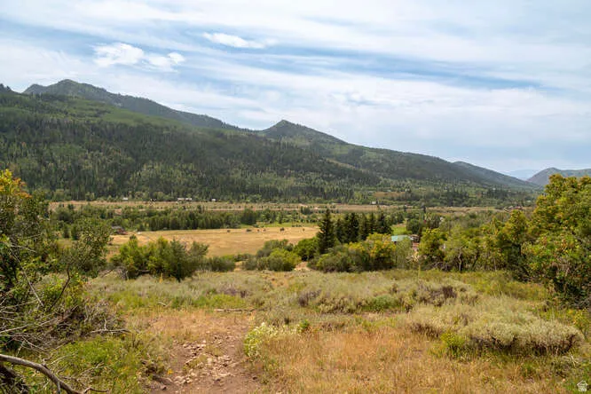View of mountain backdrop with rural landscape