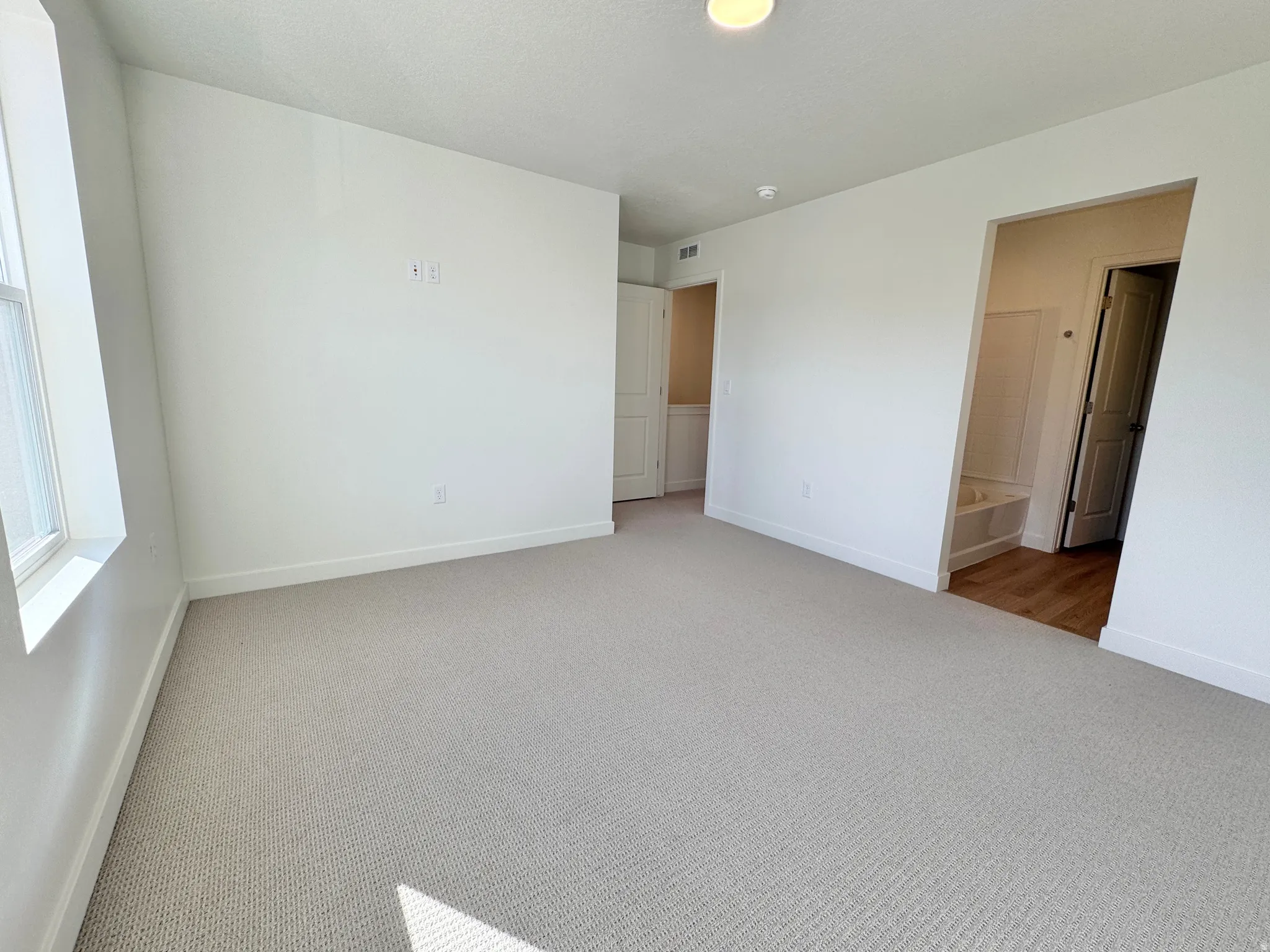 Unfurnished bedroom with carpet and baseboards