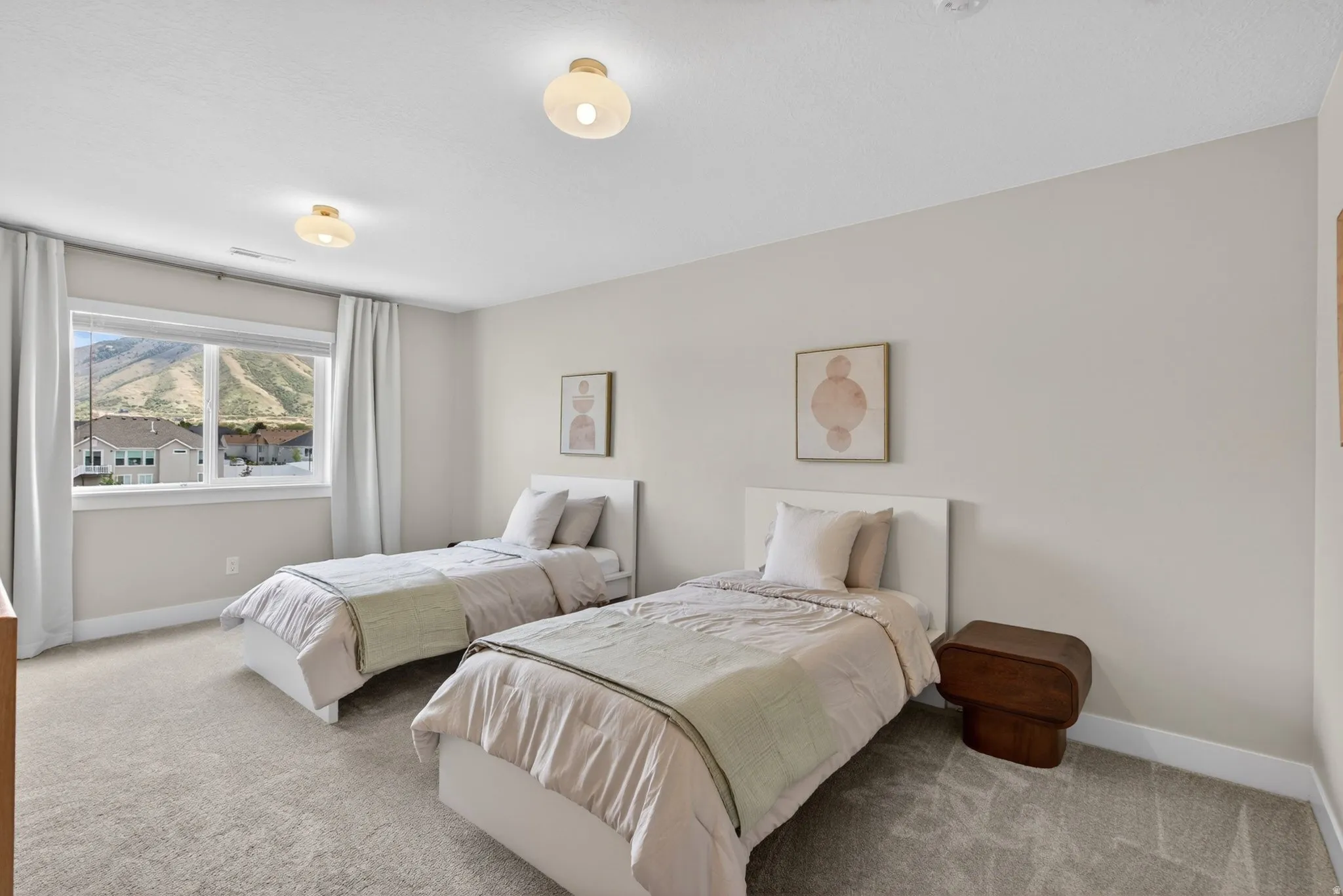 Carpeted bedroom featuring baseboards and a mountain view