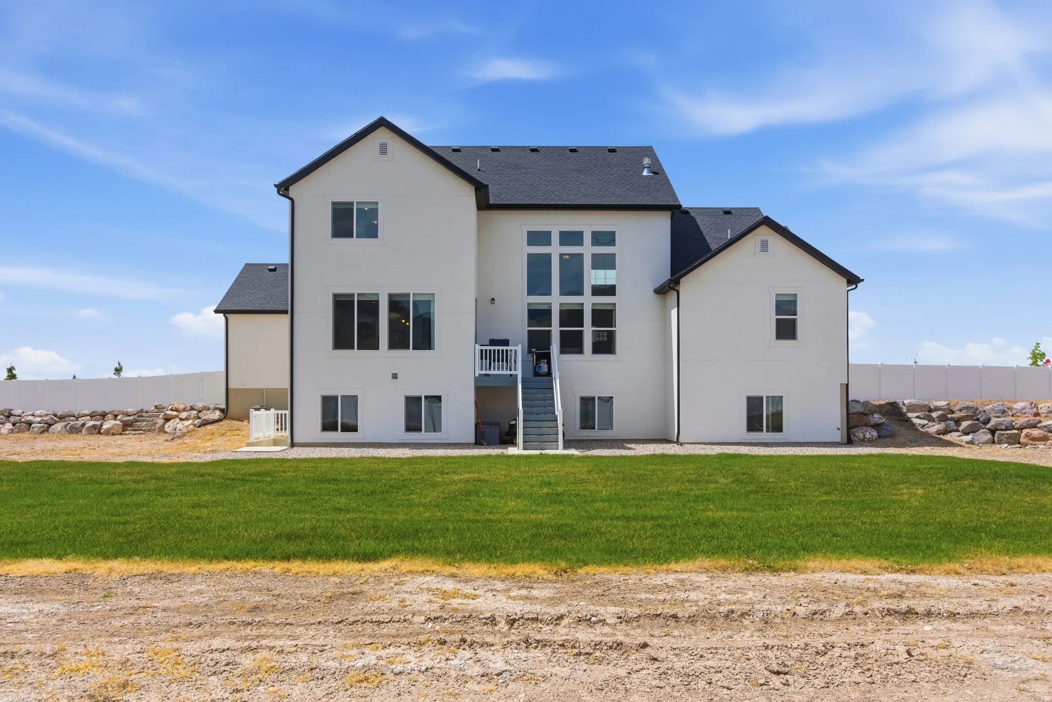 Back of property with a patio area, stucco siding, a yard, and a shingled roof