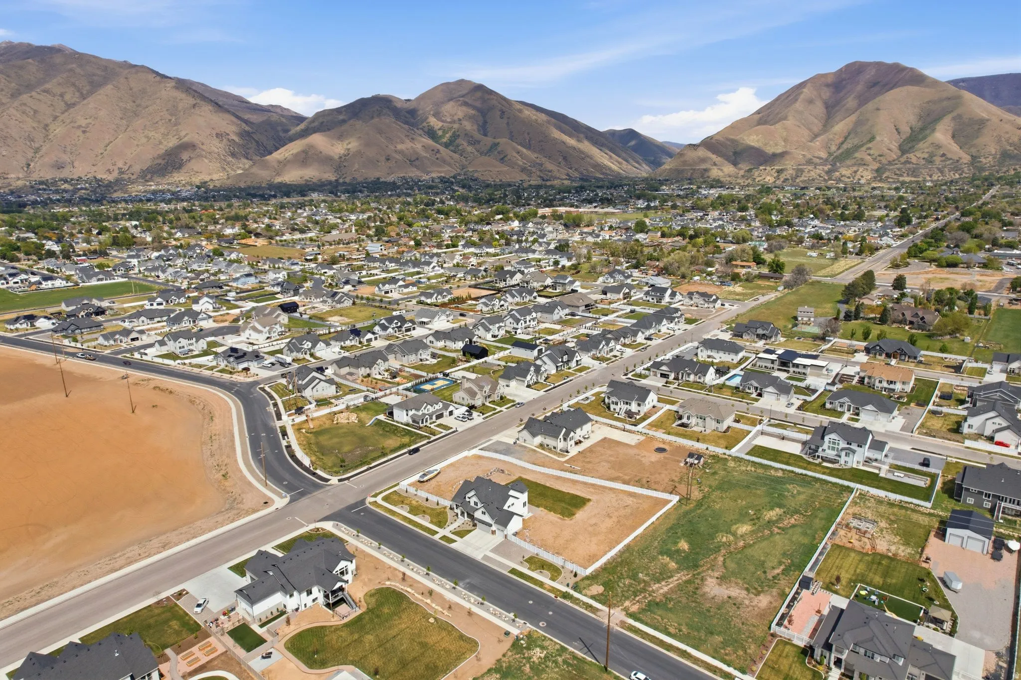 Aerial view of property's location featuring nearby suburban area and a mountainous background