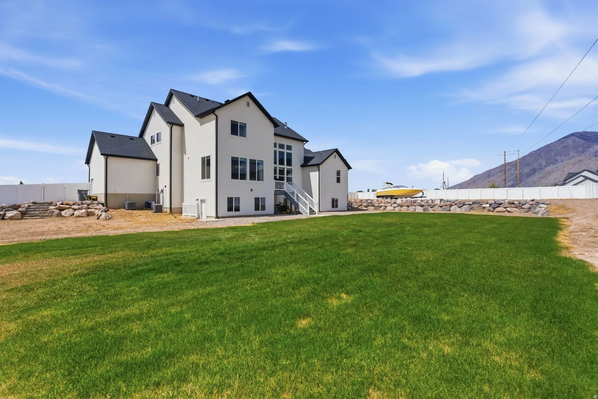 Back of house with stucco siding and a mountain view