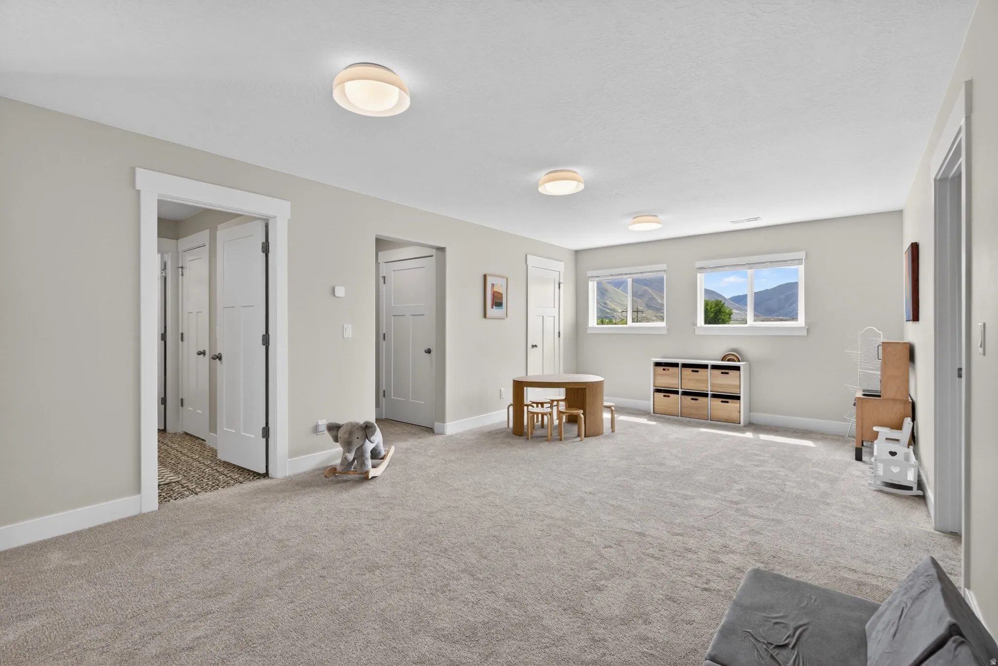Sitting room featuring light colored carpet