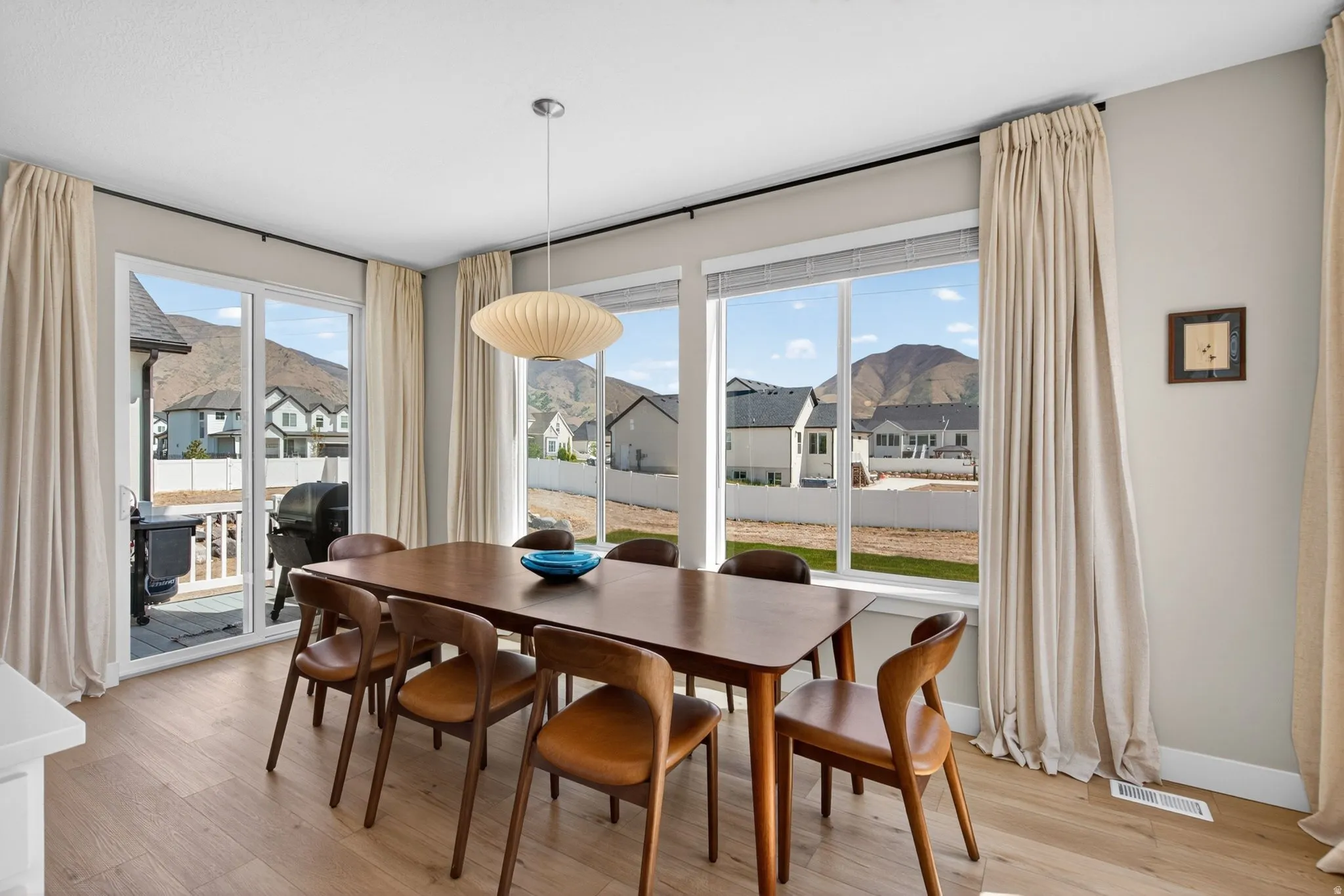 Dining area featuring light wood-style flooring and a residential view