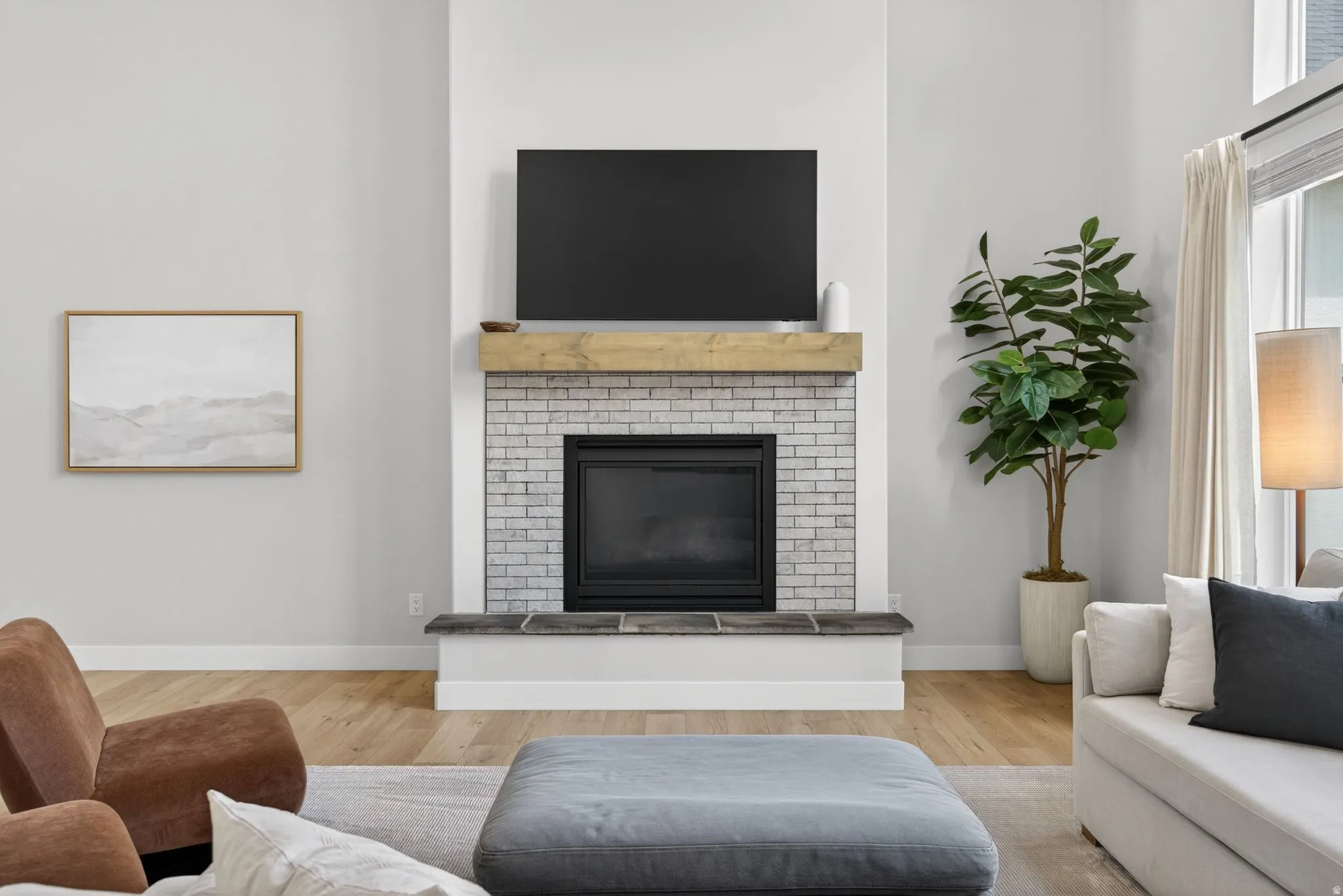 Living room with light wood-type flooring and a fireplace