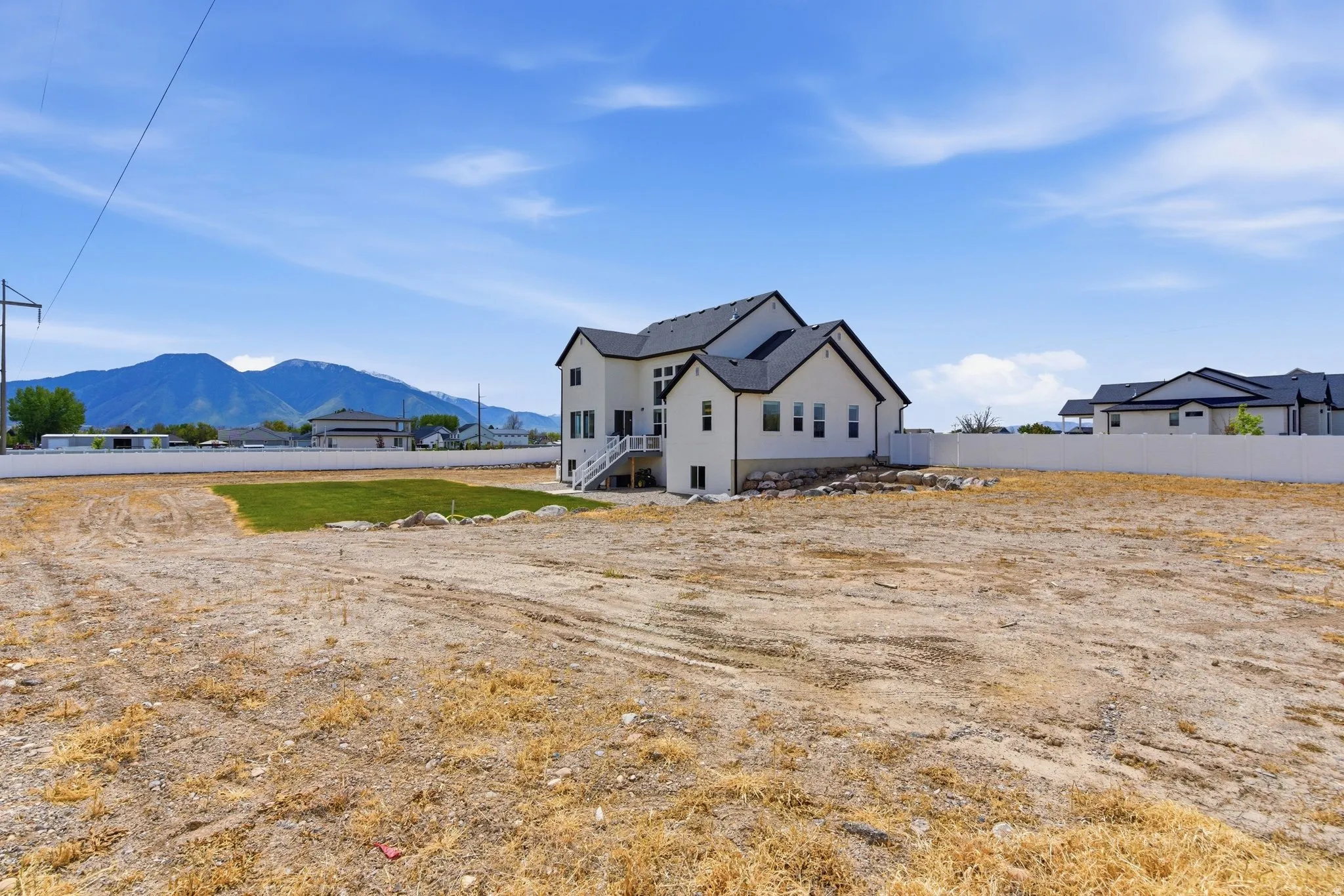 Back of property featuring a mountain view and stucco siding