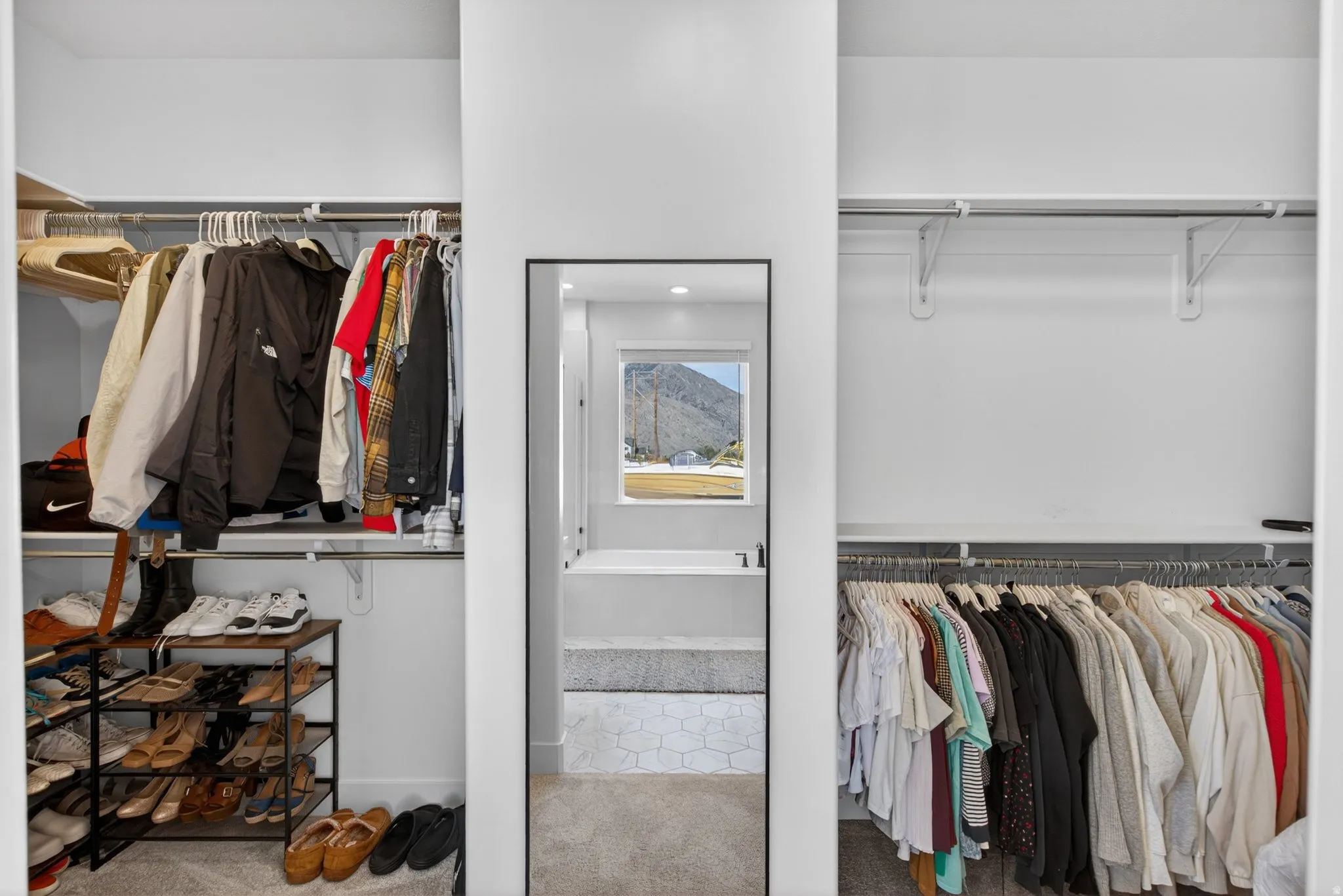Walk in closet with carpet flooring