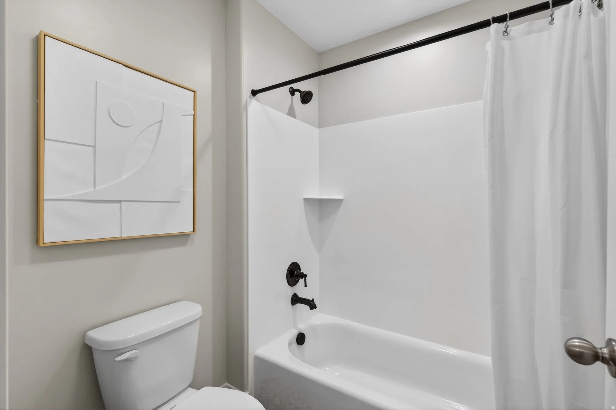 Bathroom with toilet and shower / bath combo