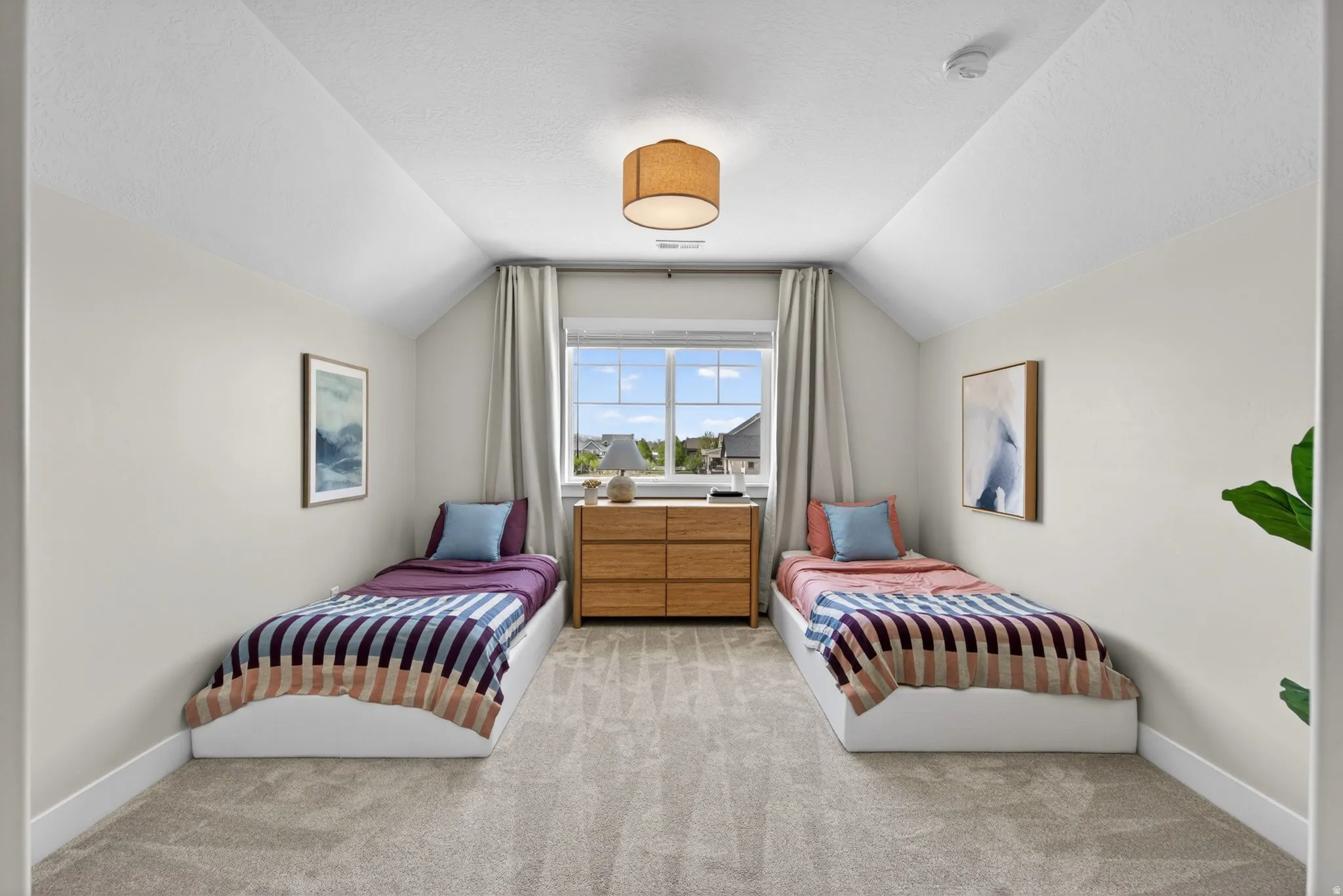 Bedroom featuring light colored carpet and a textured ceiling