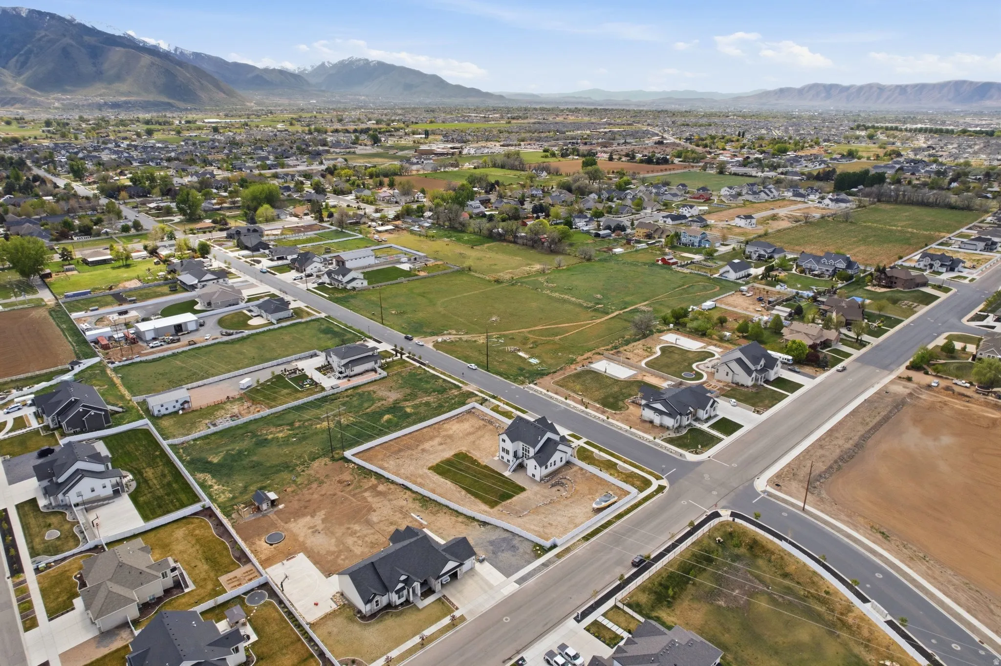 Aerial view of property's location featuring nearby suburban area and a mountain backdrop