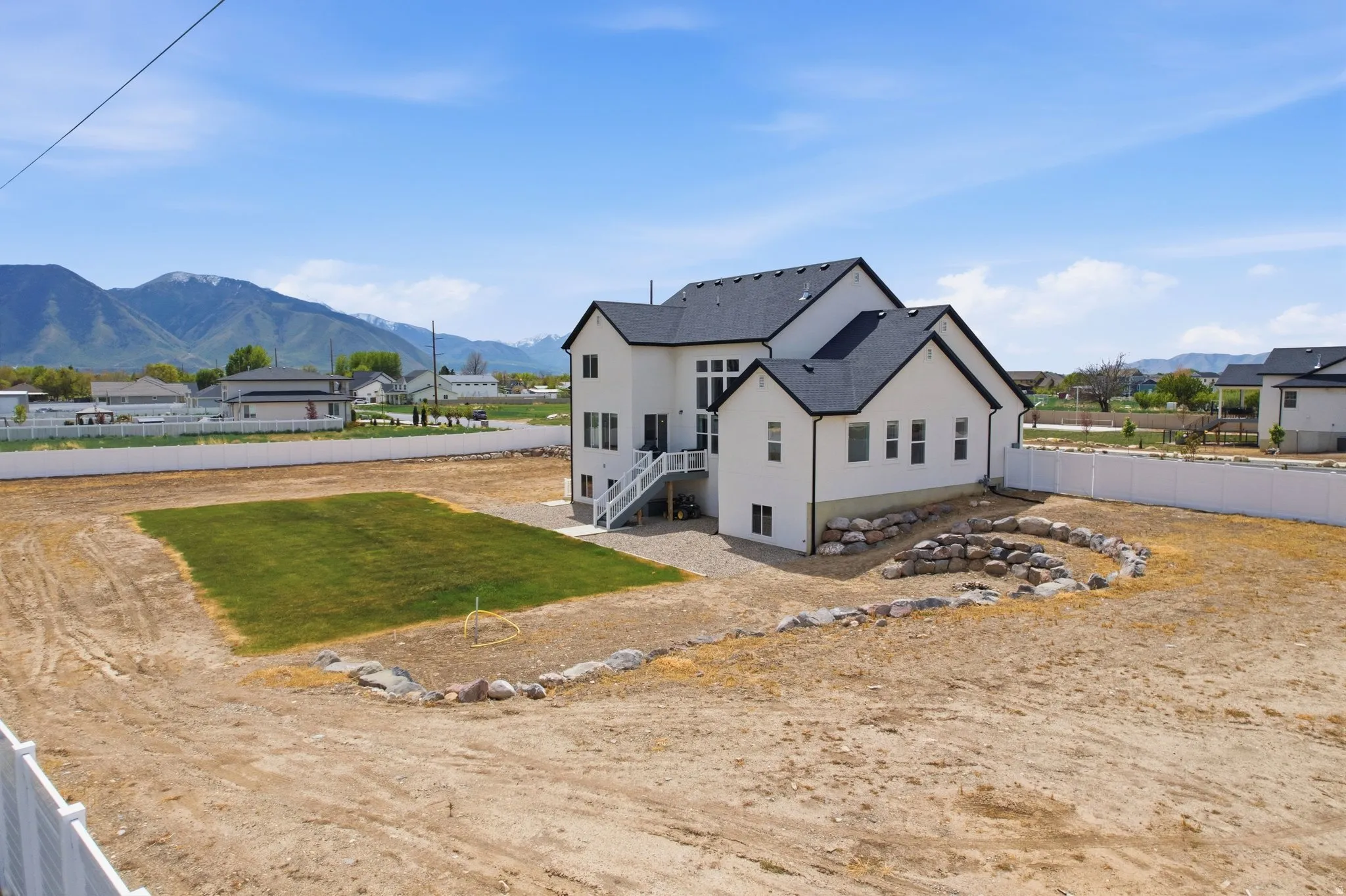 Rear view of house featuring a mountain view and a residential view