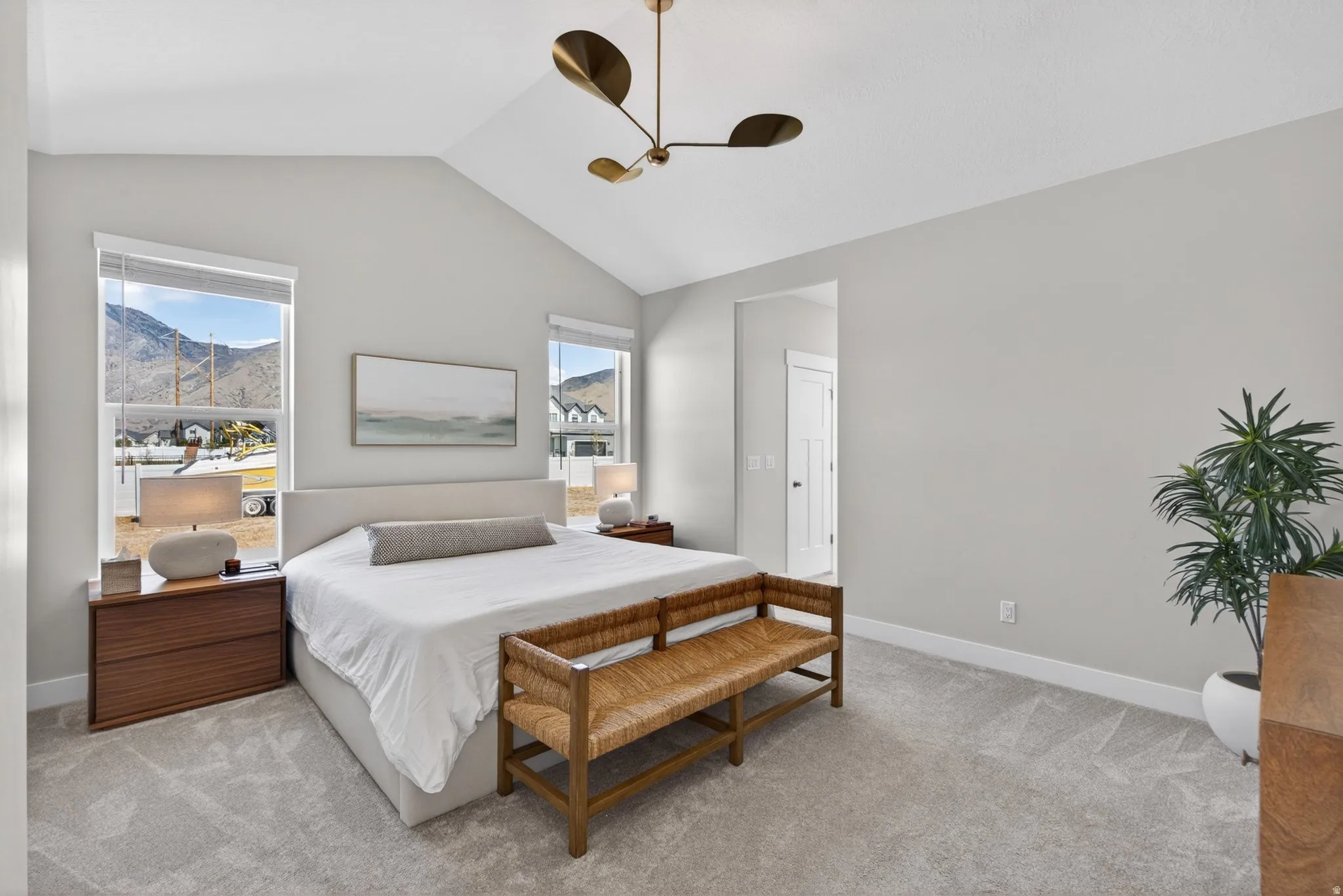 Bedroom featuring light colored carpet, a ceiling fan, and a mountain view