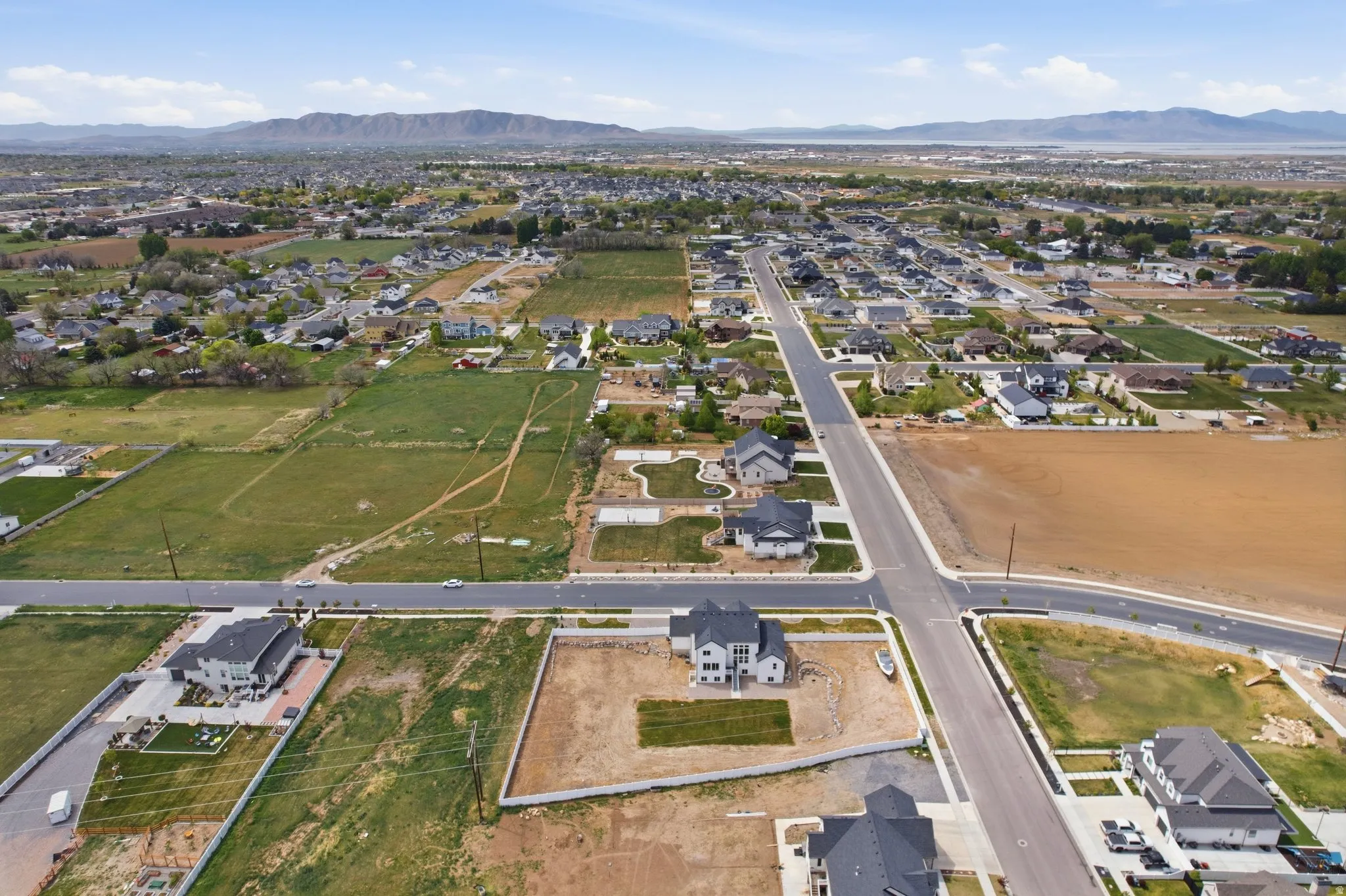 Aerial overview of property's location featuring nearby suburban area and a mountainous background