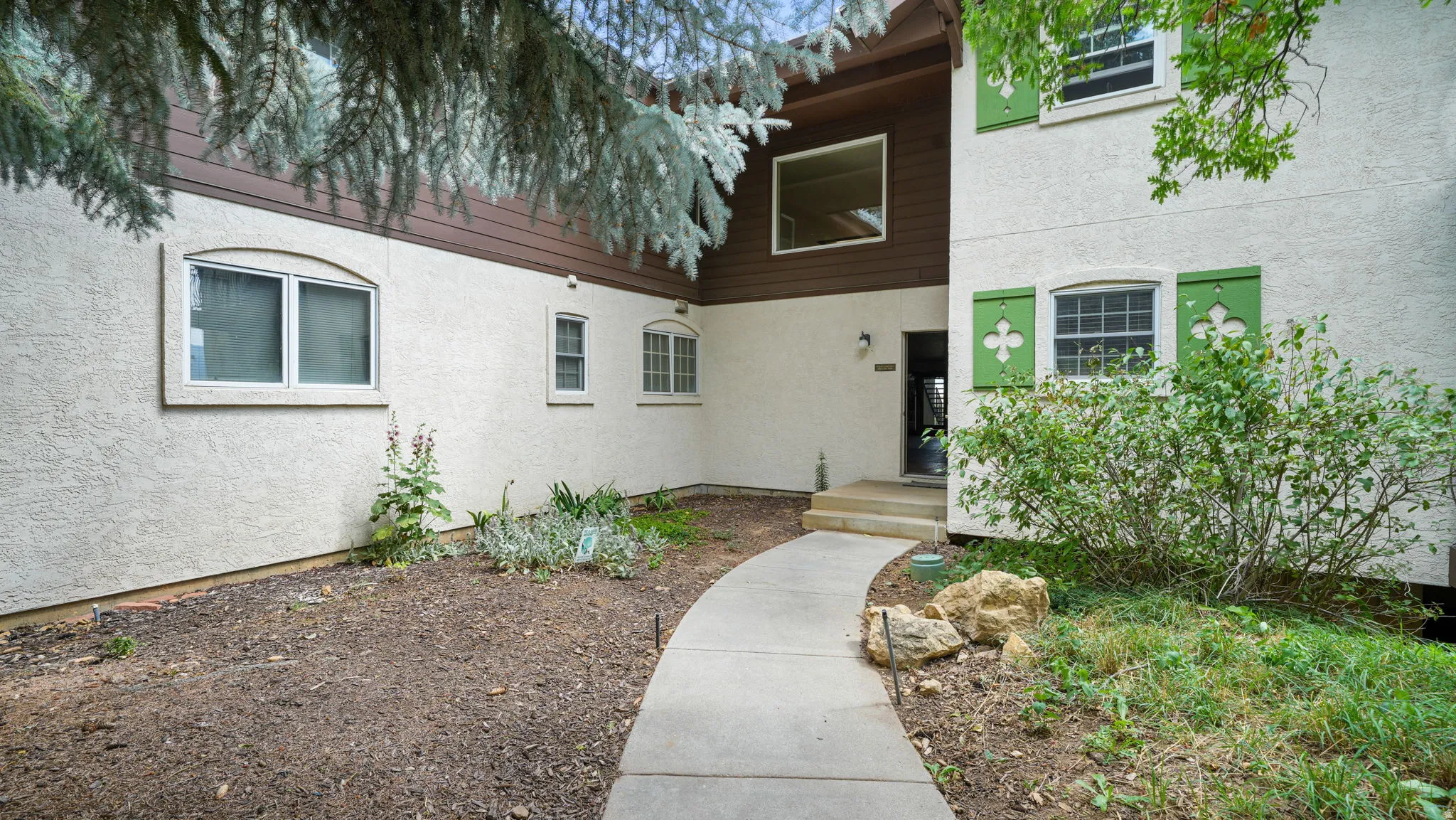 View of exterior entry featuring stucco siding