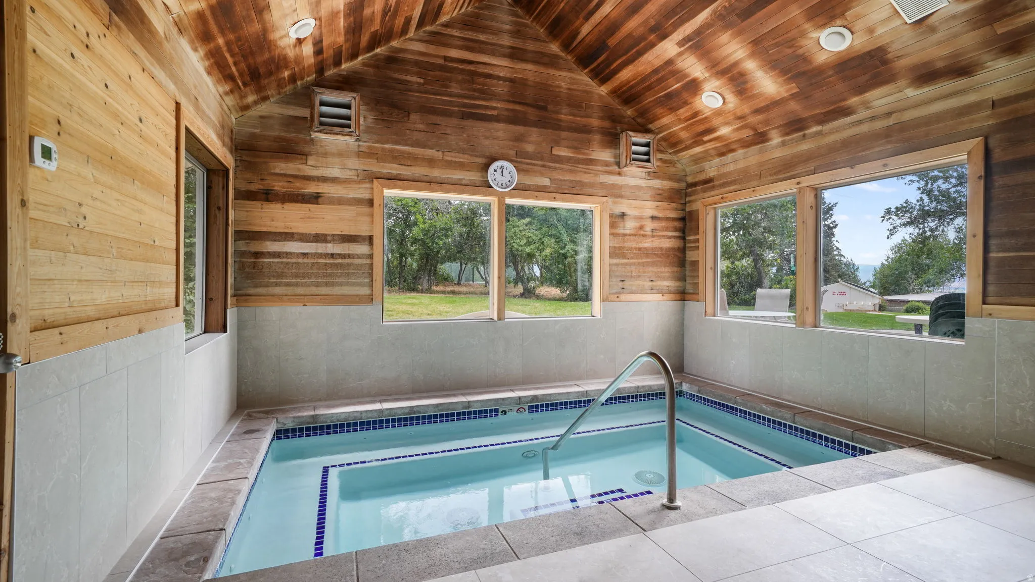 View of pool featuring a hot tub, a sunroom, and a swimming pool