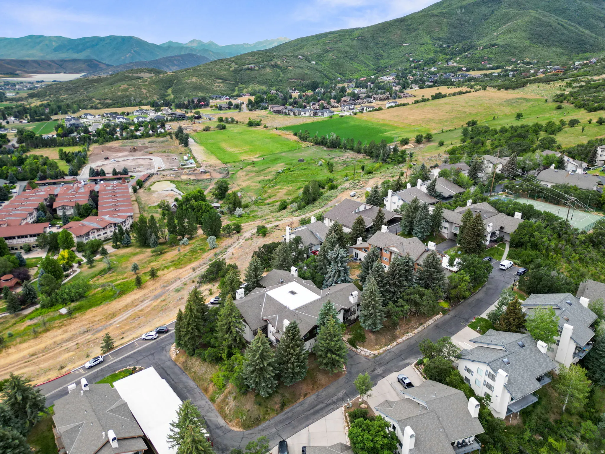 Aerial view of property's location with nearby suburban area and a mountainous background
