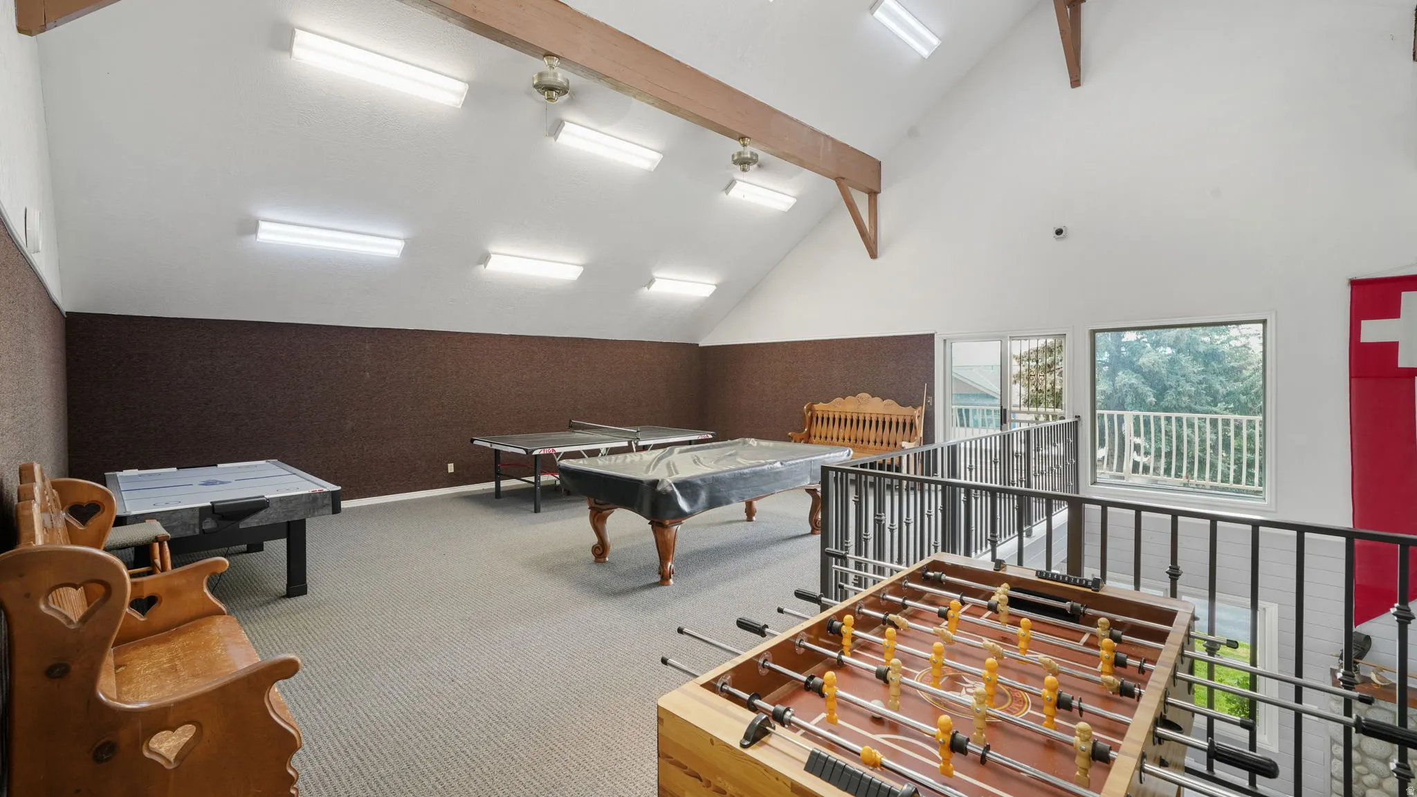 Recreation room with lofted ceiling and billiards table