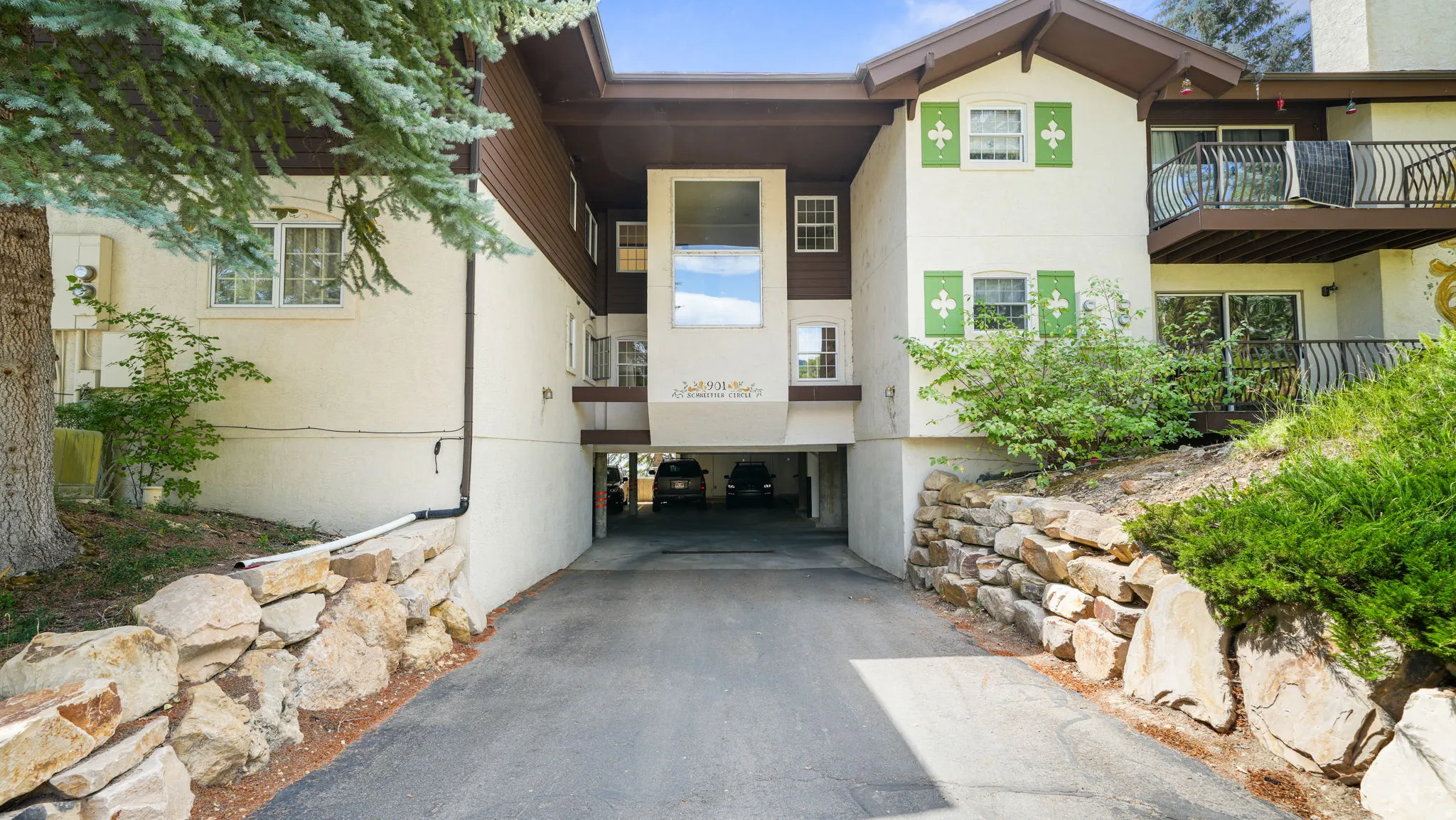 Property entrance with stucco siding and driveway