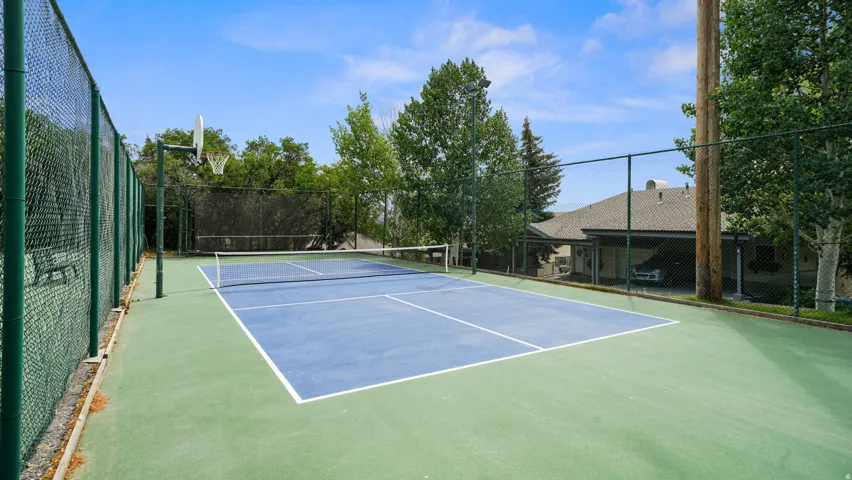 View of tennis court featuring community basketball court