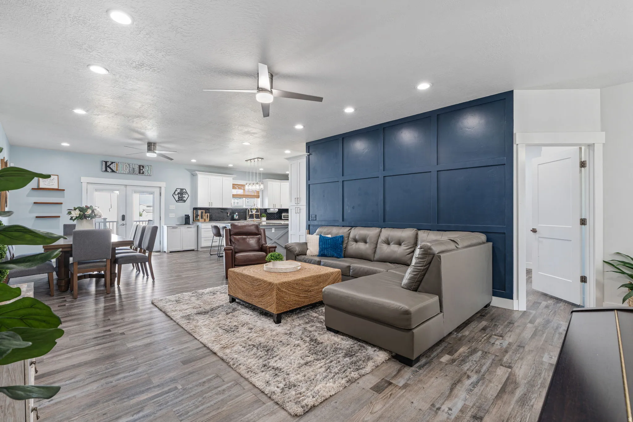 Living room featuring recessed lighting, light wood-style floors, a ceiling fan, and french doors